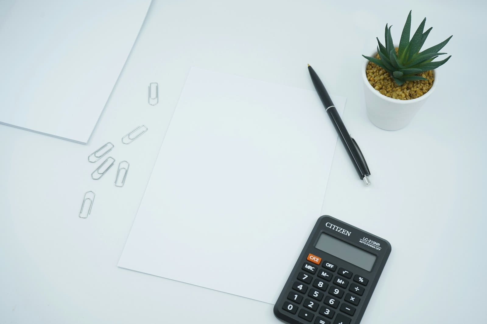 Calculator and financial paperwork on a desk
