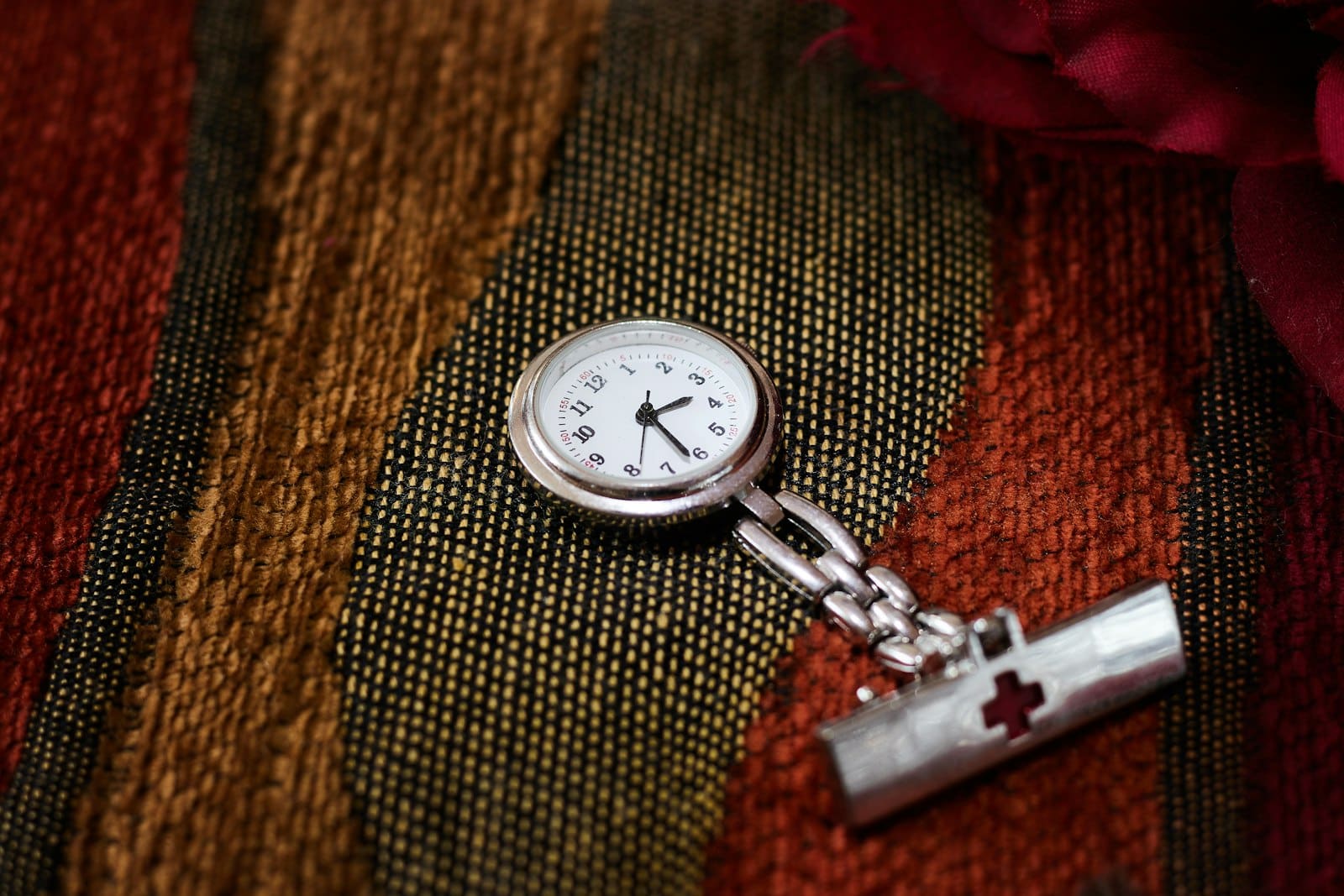 A nurse's fob watch, evoking long NHS service