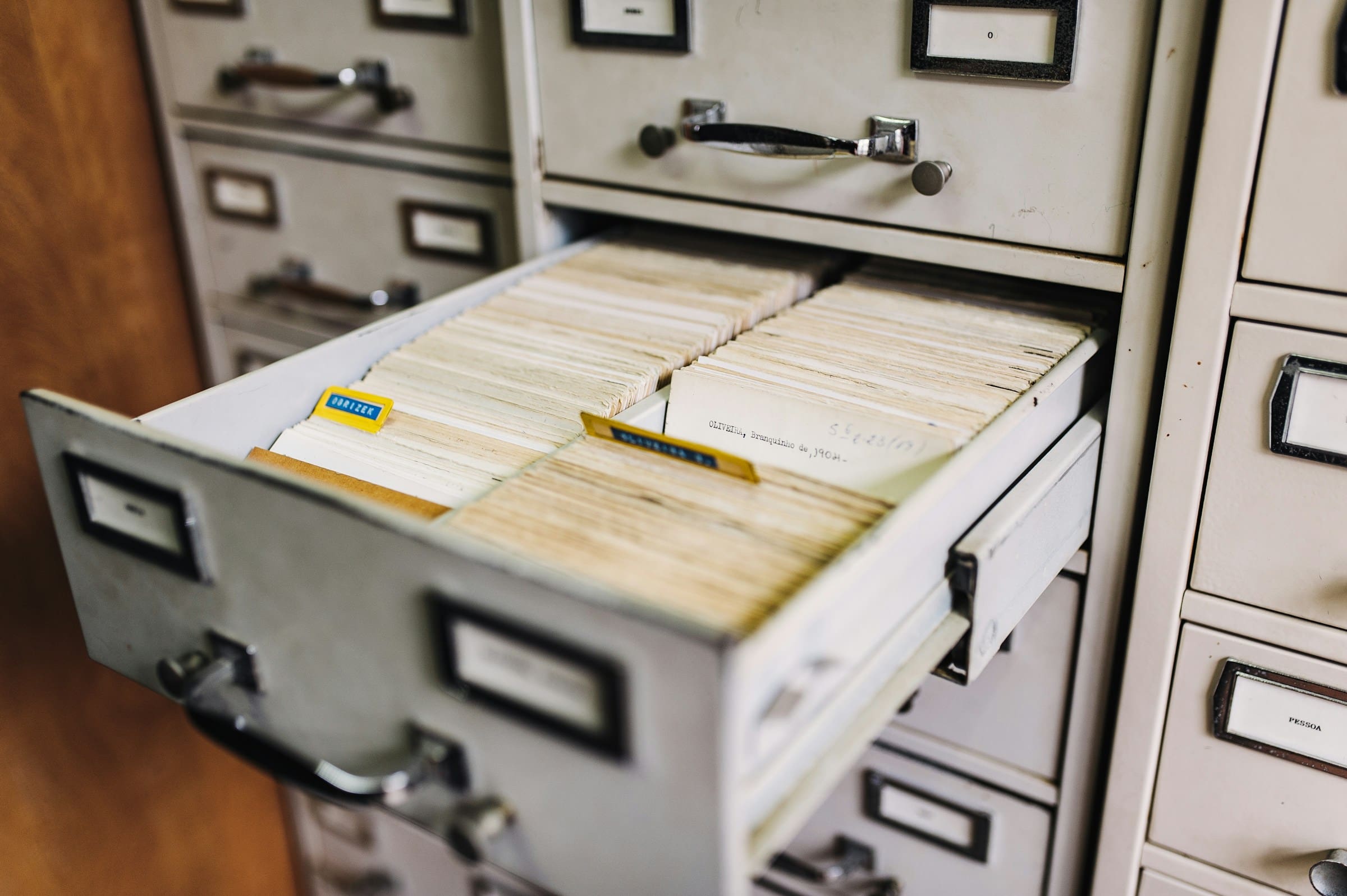 Rows of paper files packed tightly on archive shelves